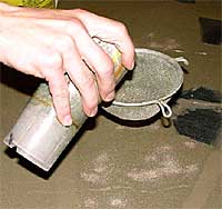 Pouring the sand through a strainer